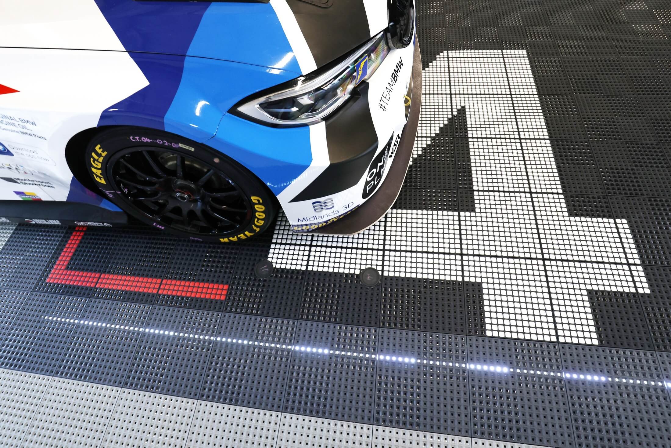 Load video: Versoflor modular garage flooring in motorsport