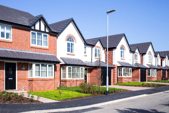 Row of brick houses with white windows on a clear day
