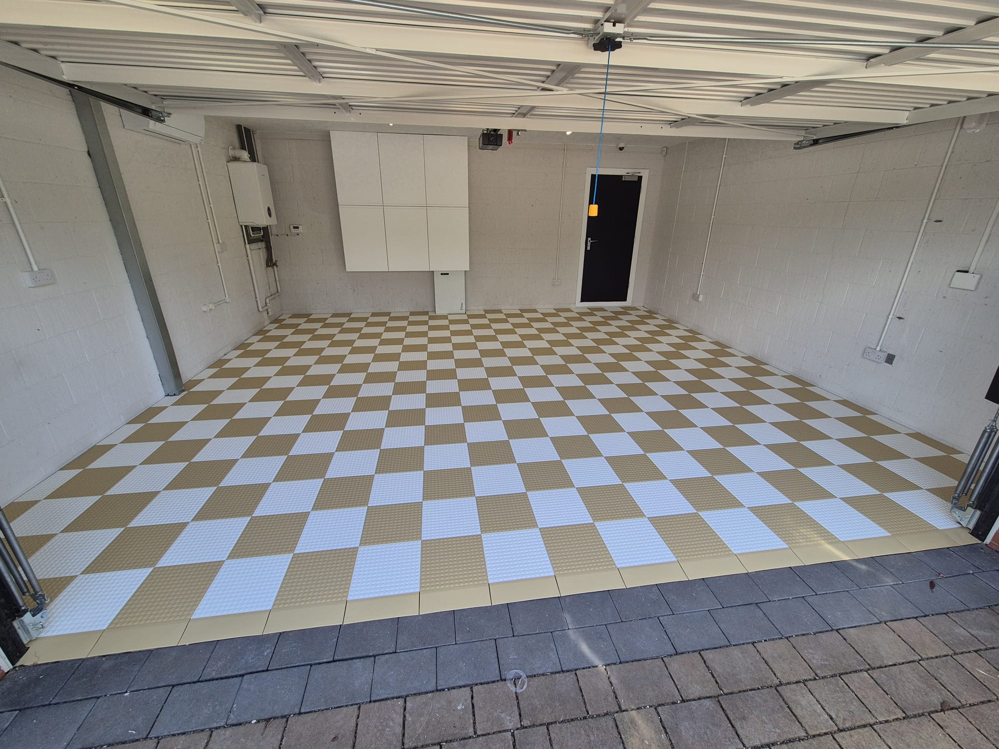 White and gold versoflor garage flooring tiles installed with edges.
