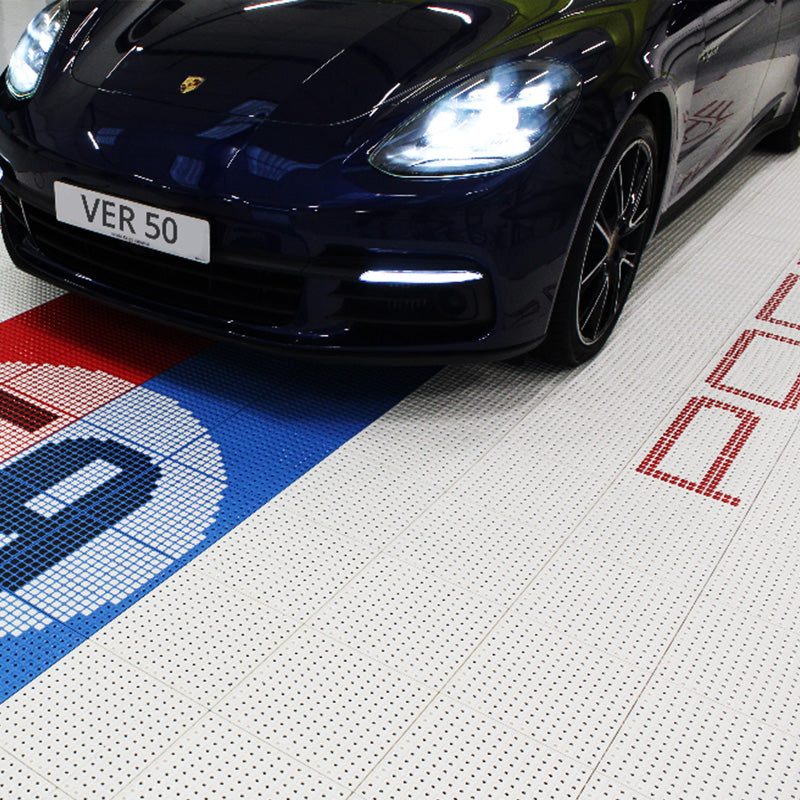 porsche parked on white garage tiles